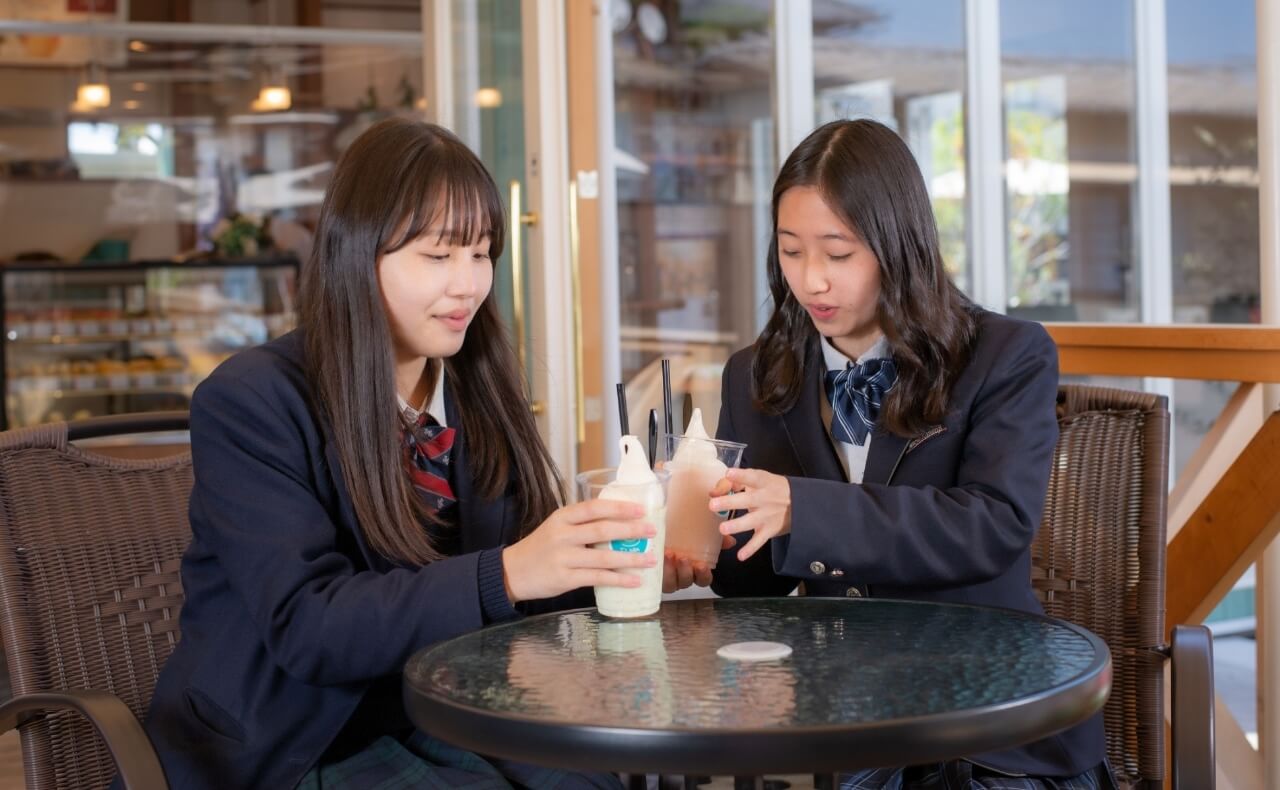イートインスペースでソフトクリームを食べる女子高校生